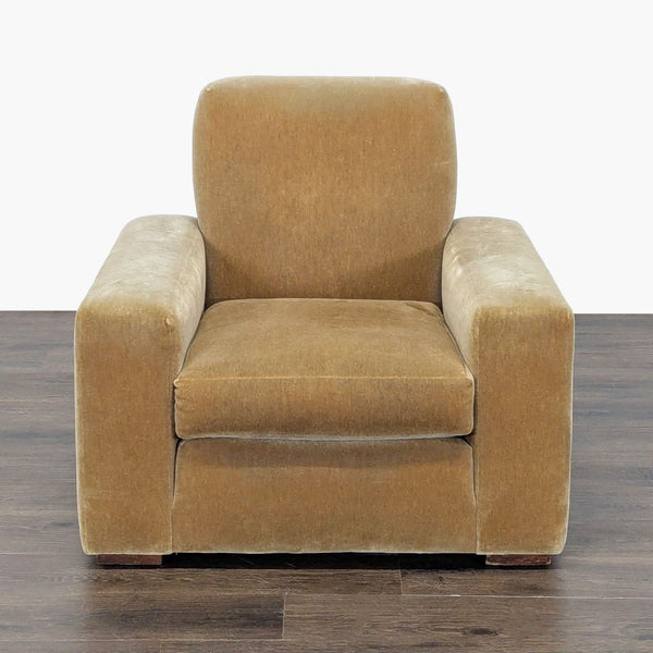 Mustard brown lounge chair with plush cushions and wide arms, ideal for relaxing in living rooms.  