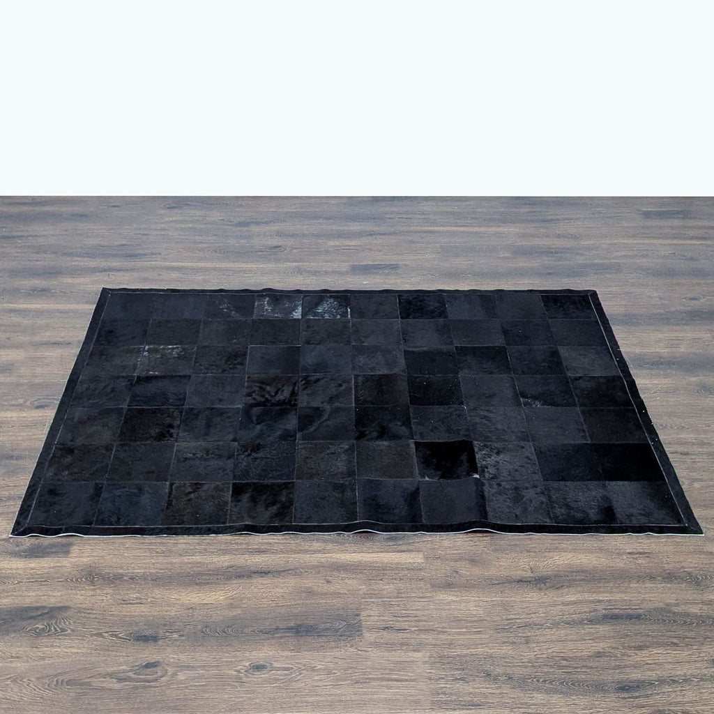 Modern black cowhide rug by Restoration Hardware, blending unique pattern and texture for versatile home décor.