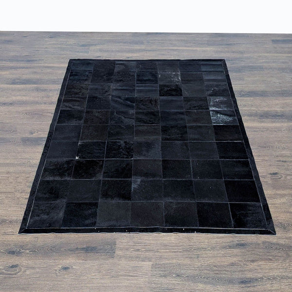 Restoration Hardware cowhide rug featuring a modern black patchwork design, perfect for stylish living spaces.