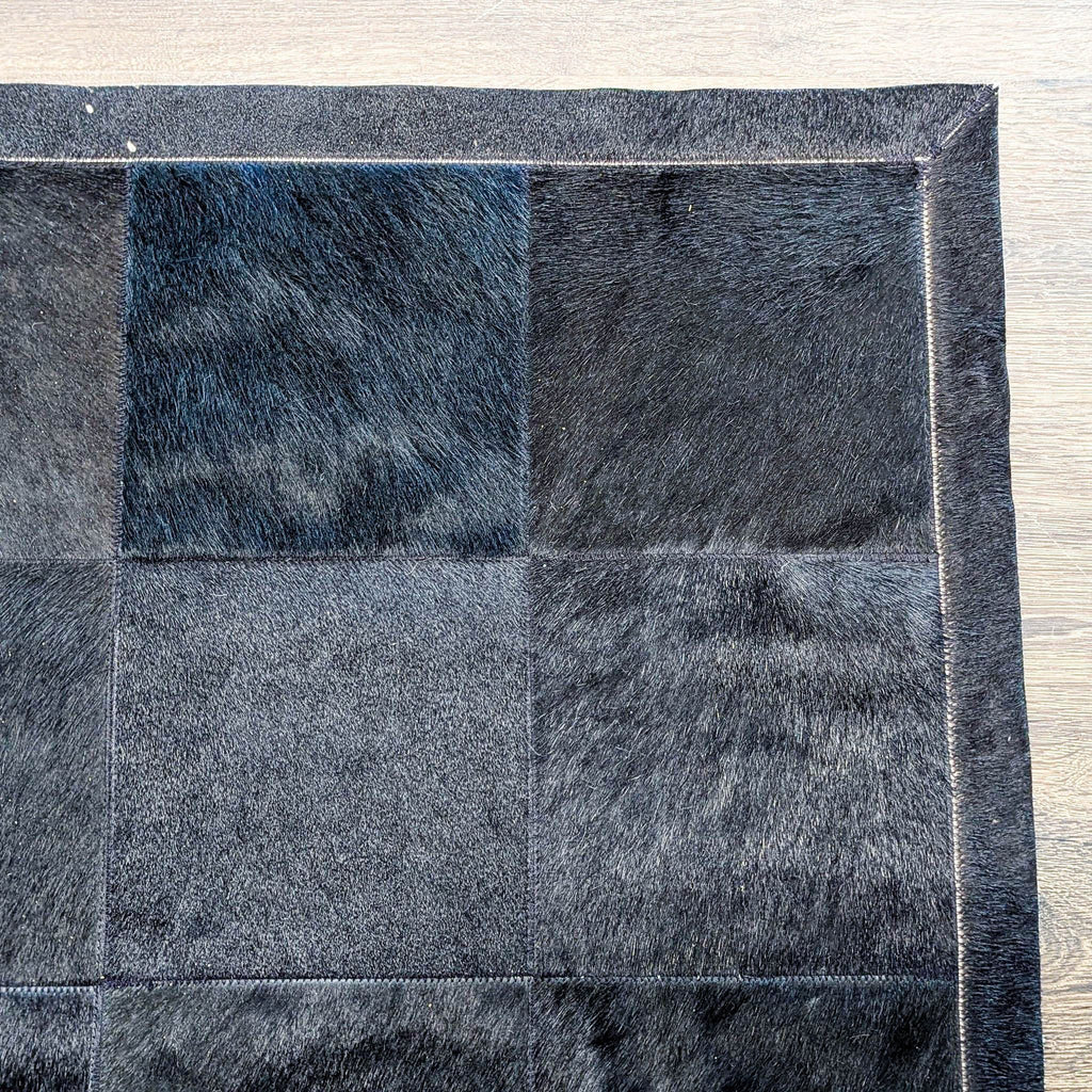 Elegant black patchwork cowhide rug from Restoration Hardware, offering a soft, sophisticated accent for any room.