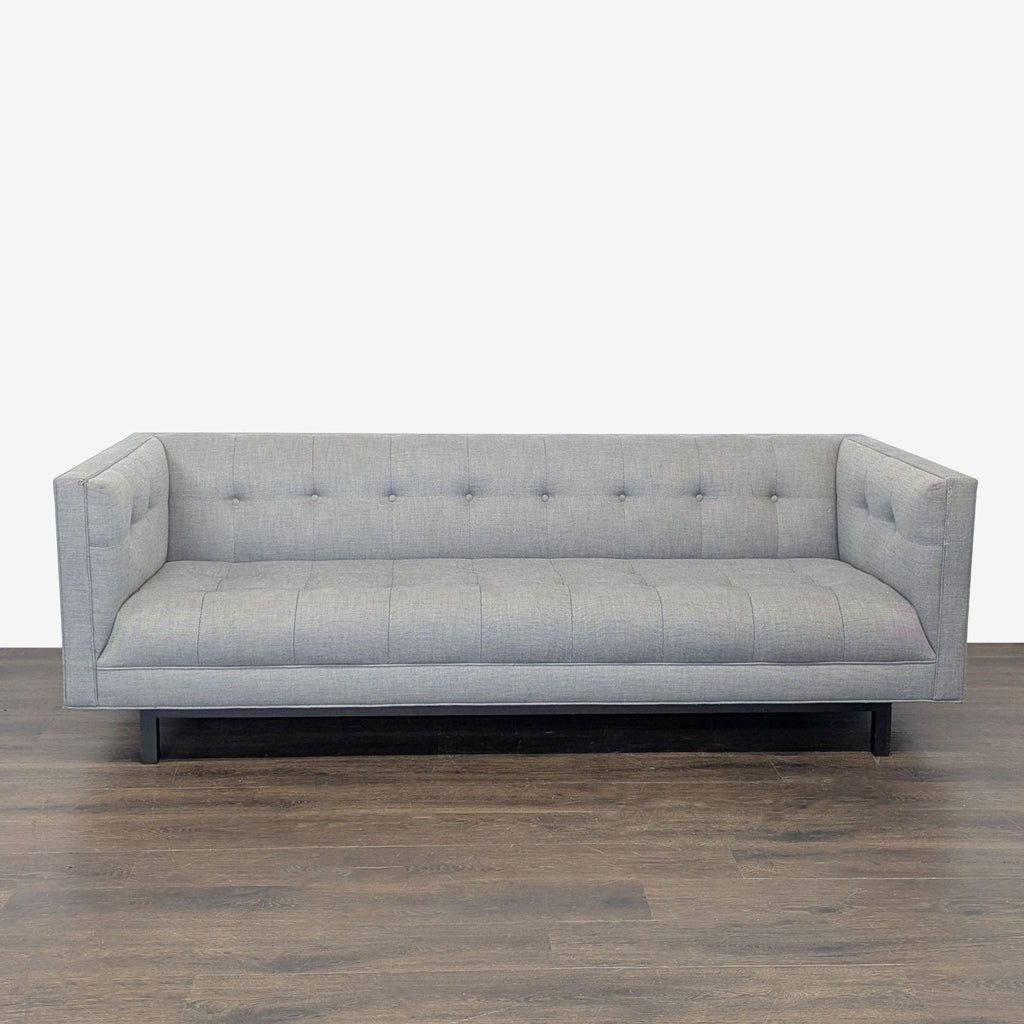Restoration Hardware 3-seat sofa with light gray fabric, button-tufted back and seat, and modern clean lines.