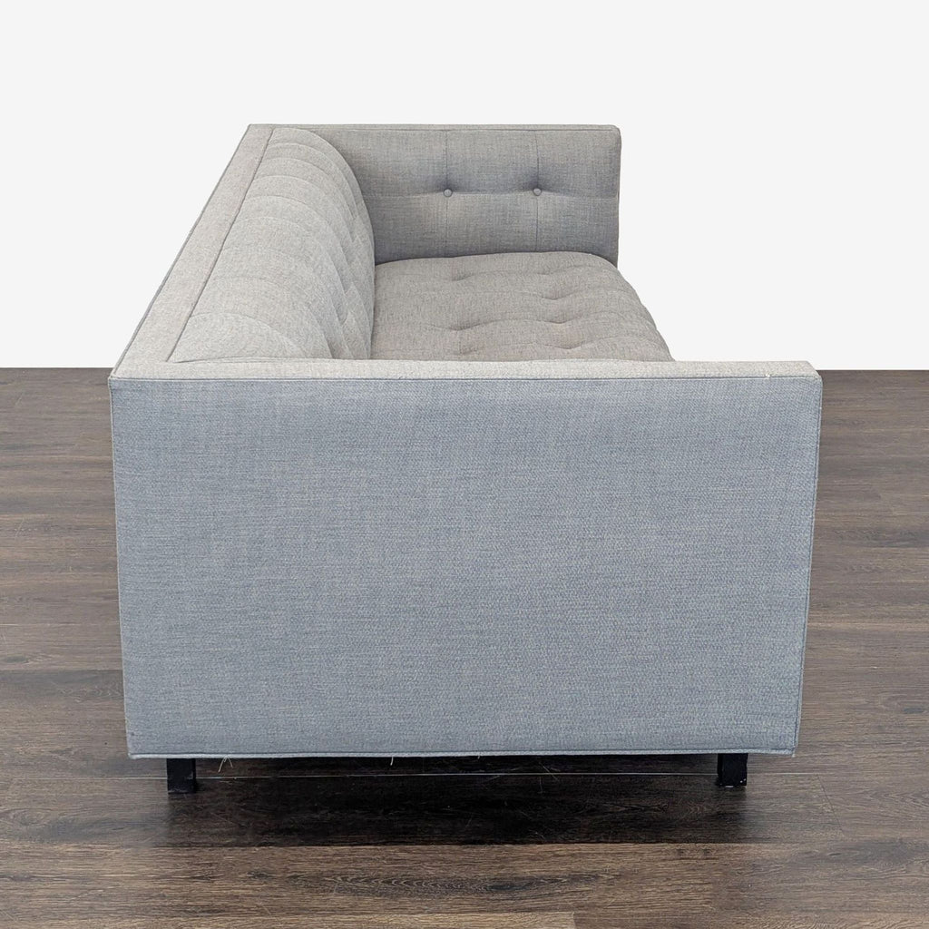 Modern 3-seat Restoration Hardware sofa in light gray upholstery, featuring stylish button-tufted detailing and sleek design.