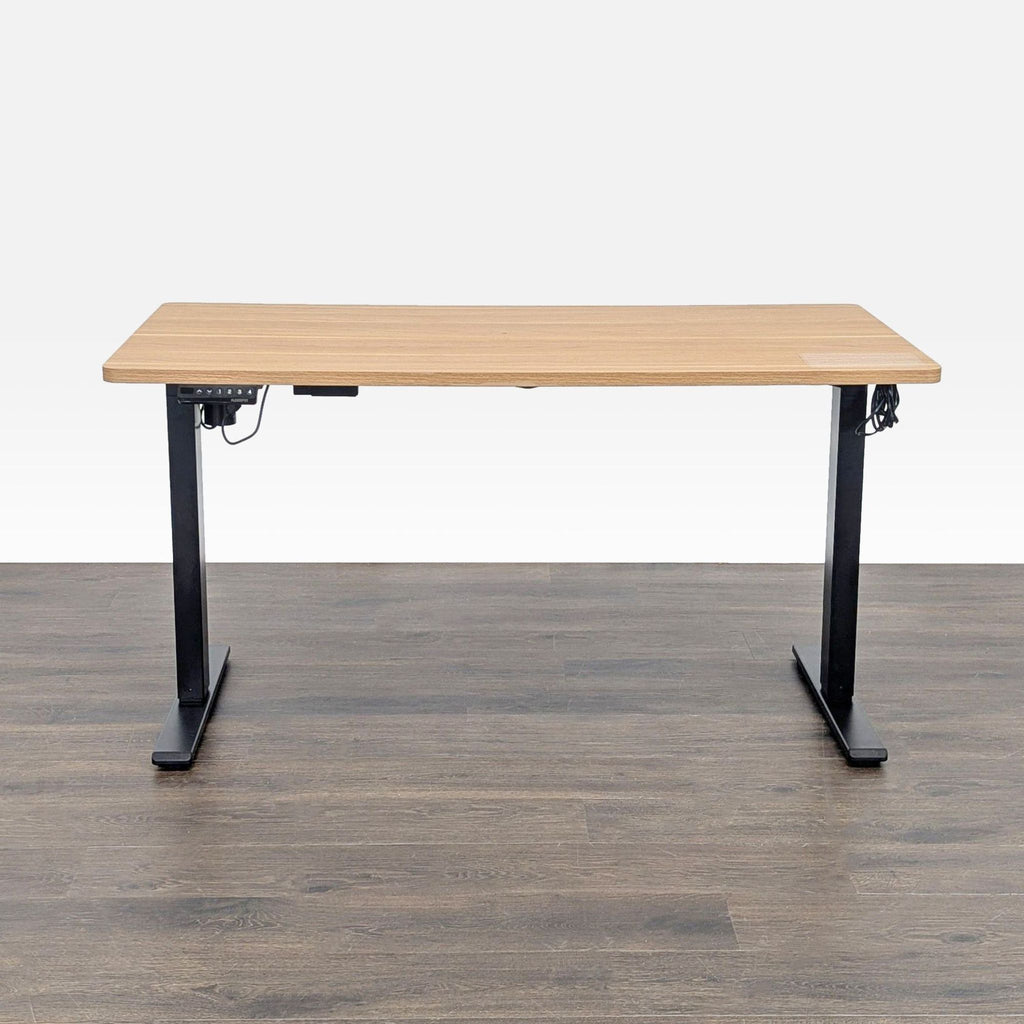 Electric standing desk by Flexispot with black metal frame and wood top, suitable for home or office use.