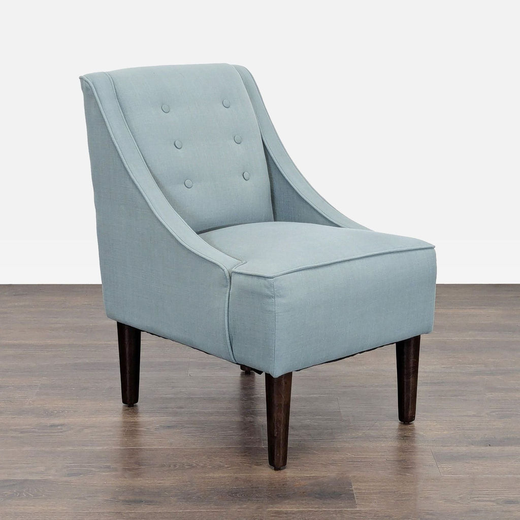 Modern blue lounge chair featuring tufted back and sturdy legs, perfect for relaxing spaces.