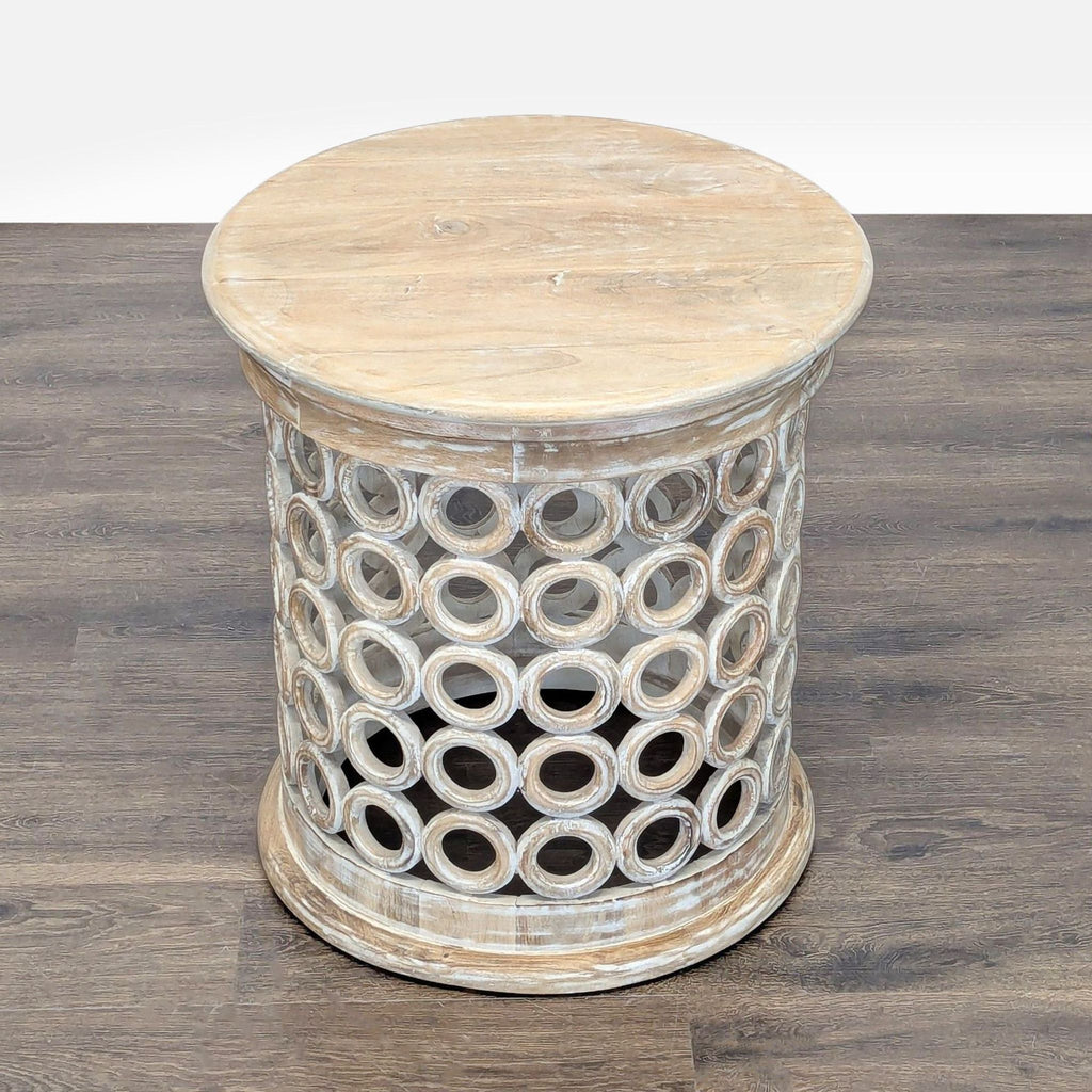 2. Rustic console table with a light wood top and open cylindrical base made of interlocking wooden rings.