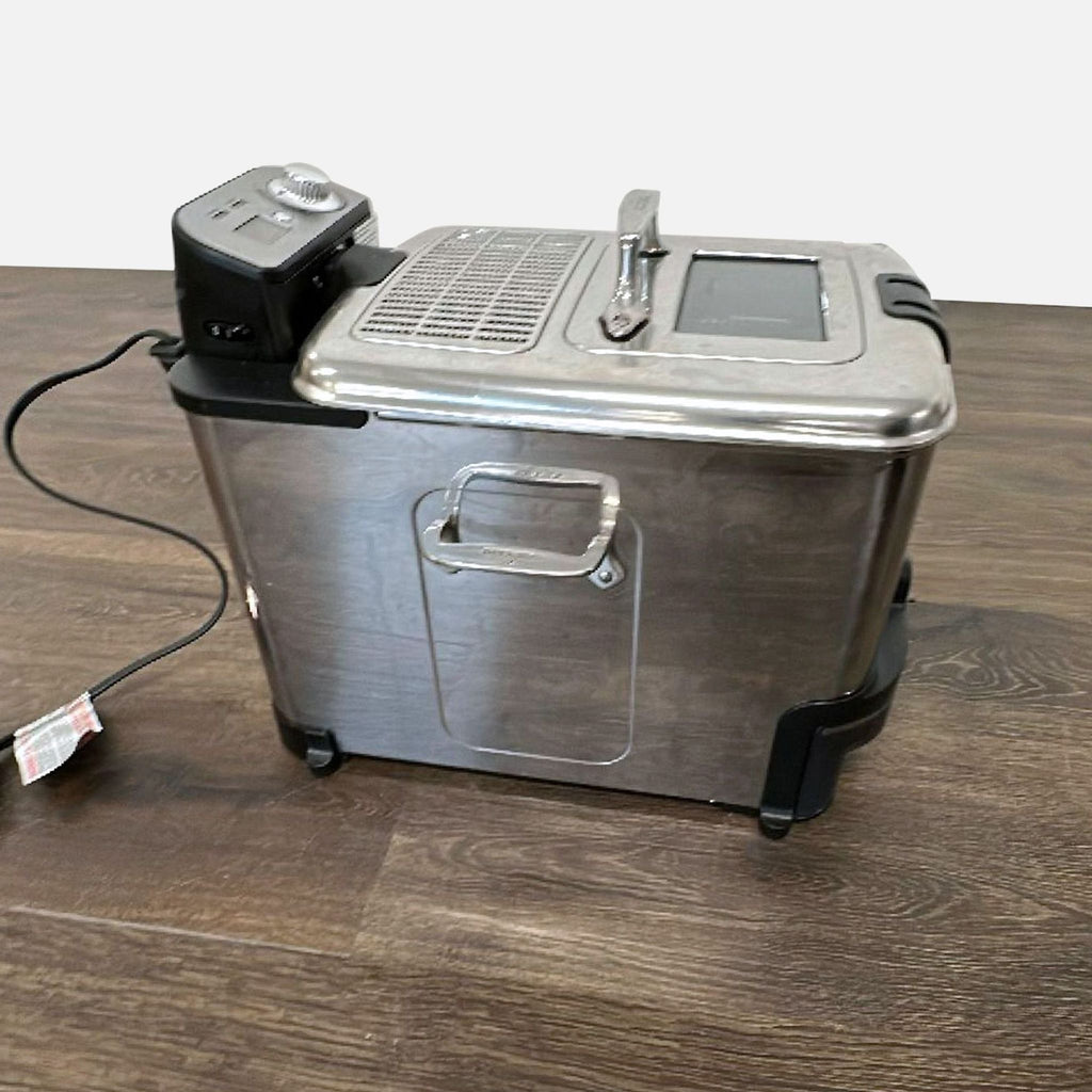 All-Clad countertop deep fryer featuring adjustable temperature dial, clear window lid, and sleek metal design.