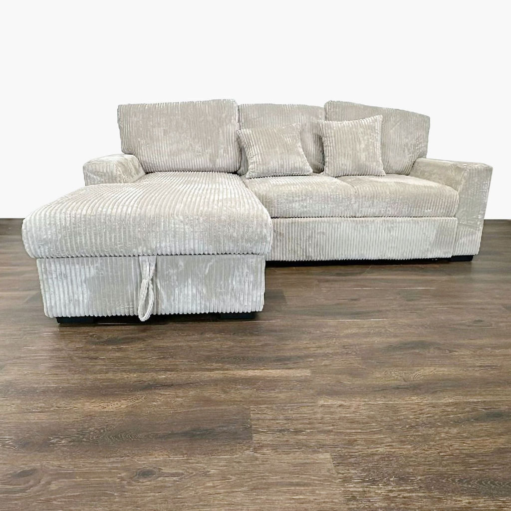 Modern sleeper sofa with plush cushions, shown in neutral upholstery and set up as a sofa bed.