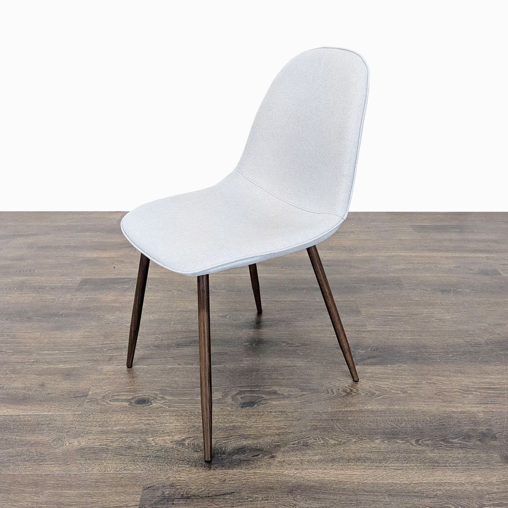 Modern mid-century chair by Dorel Home, upholstered and supported by metal legs.