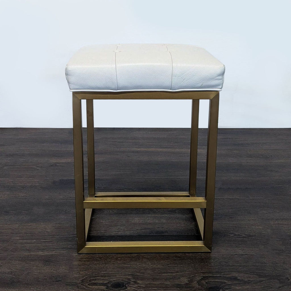 2. Modern tufted leather bench by Restoration Hardware featuring a sturdy metal base.  