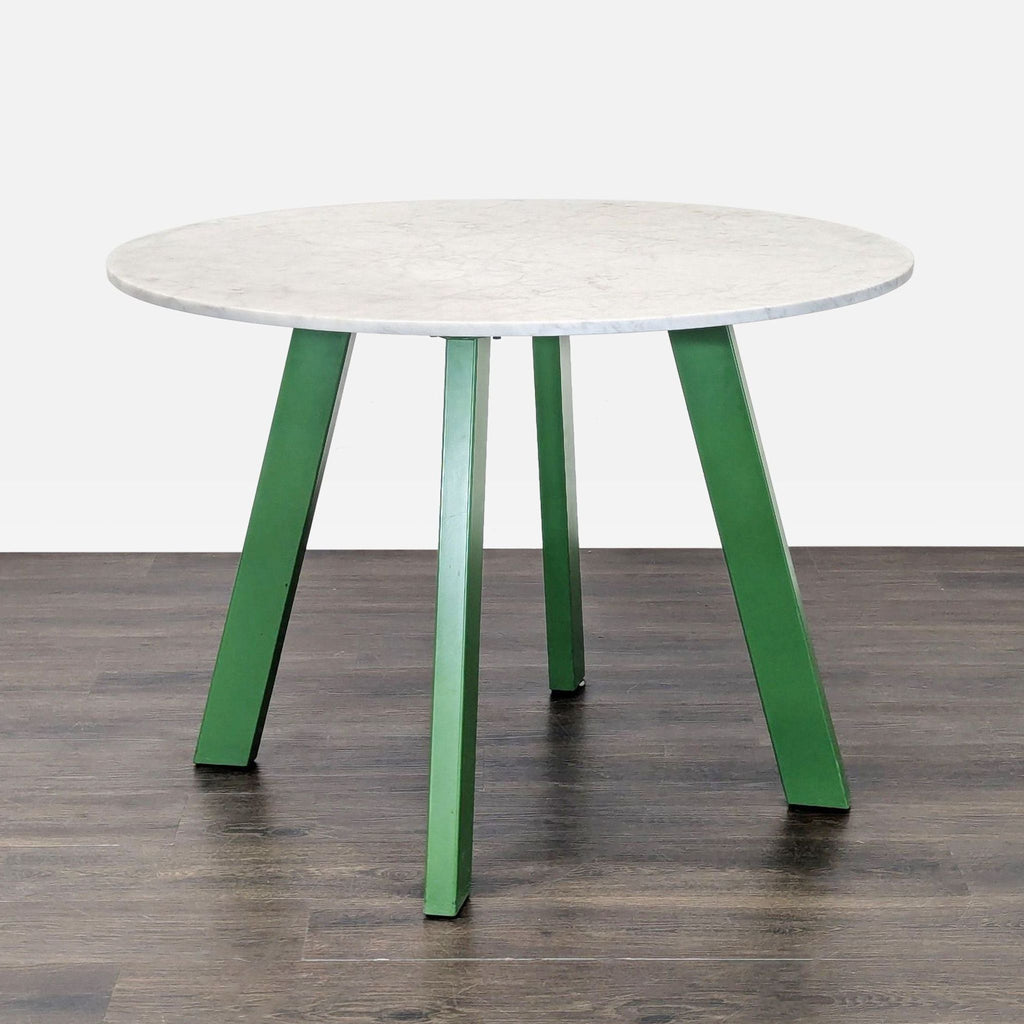 Sculptural coffee table with four steel legs and honed Carrara marble top by Blu Dot.  