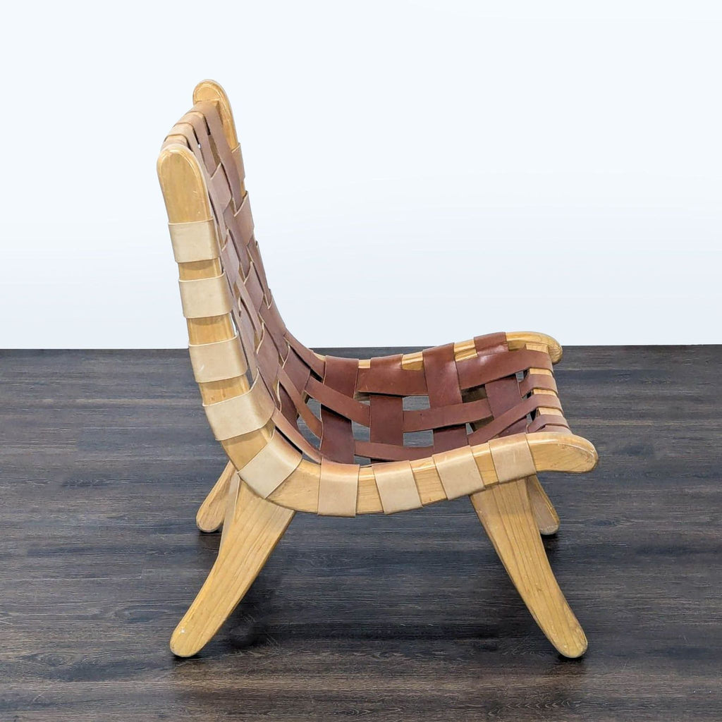 Rustic lounge chair with solid wood construction and brown leather strapping, ideal for cozy spaces.