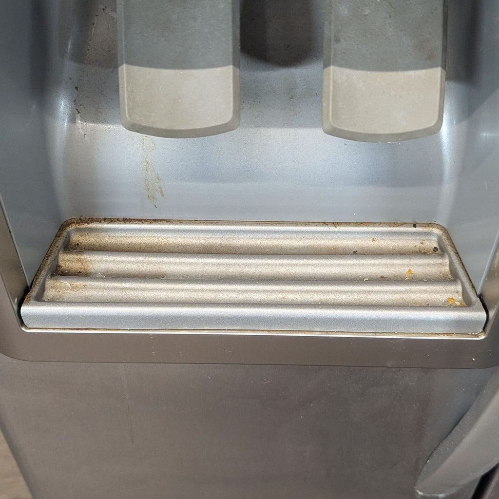 1. Stainless steel KitchenAid refrigerator with French doors and bottom freezer shown in a modern kitchen.  
