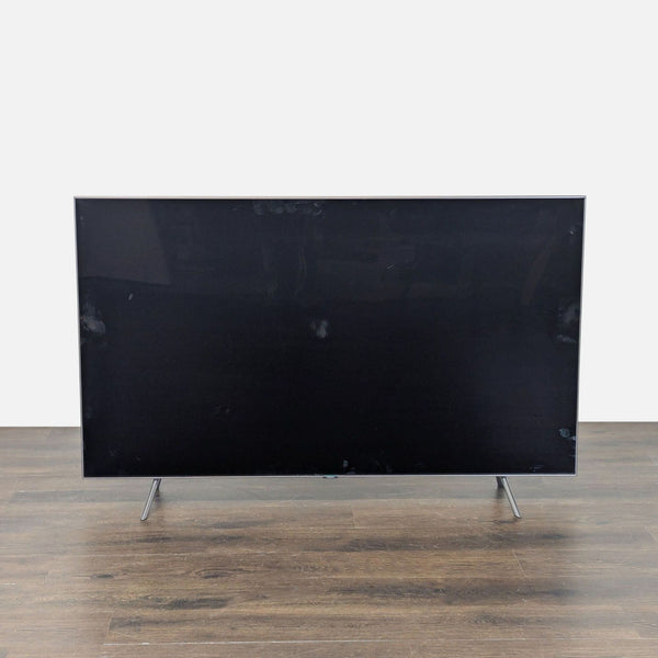 Samsung 65-inch flat LED TV with sleek design, sturdy metal legs, and sharp display in excellent condition.  