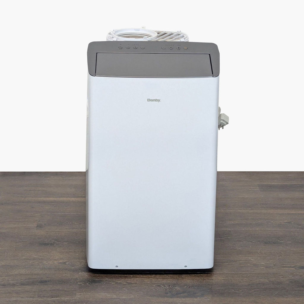 Danby portable air conditioner with sleek design and top control panel, ideal for efficient room cooling.