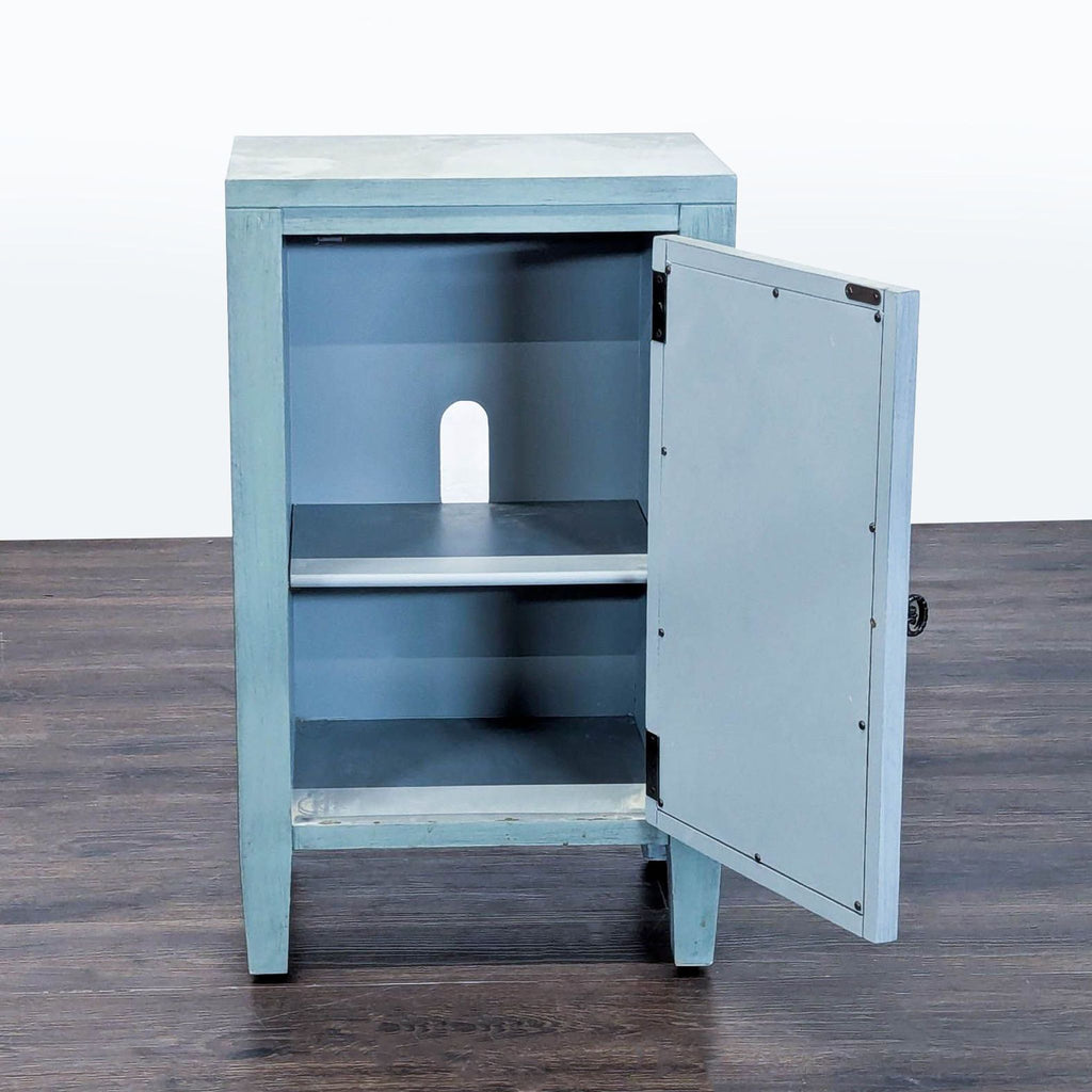 Turquoise Leighton cabinet featuring antique mirrored door, open fretwork design, and interior media storage shelf.