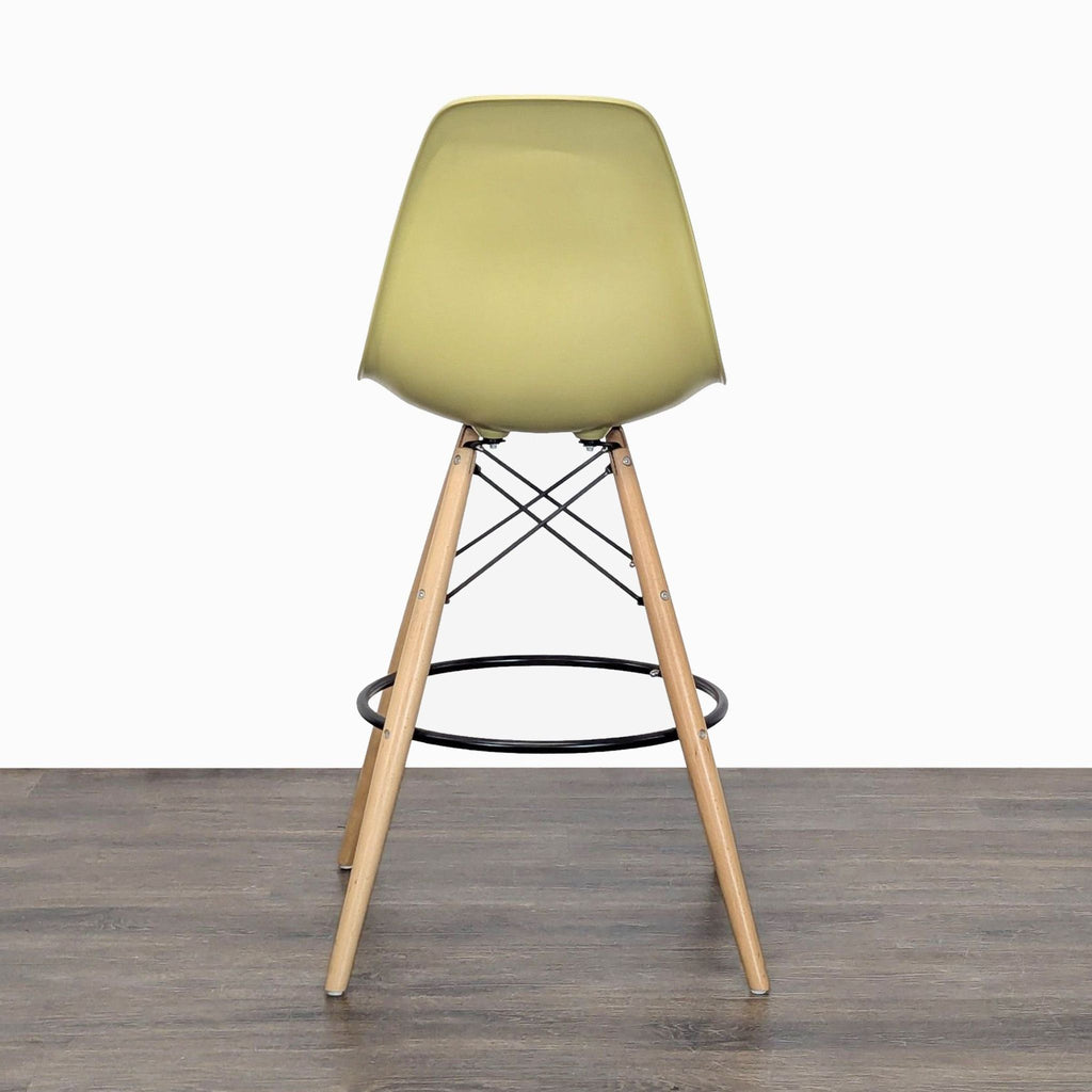 Modern bucket-seat stool in white plastic, wooden legs, and supporting metal footrest, Mod Made brand.