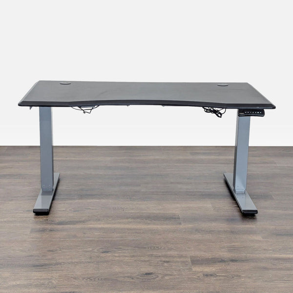 FlexiSpot electric standing desk with spacious black surface and digital control panel for adjustable height.  