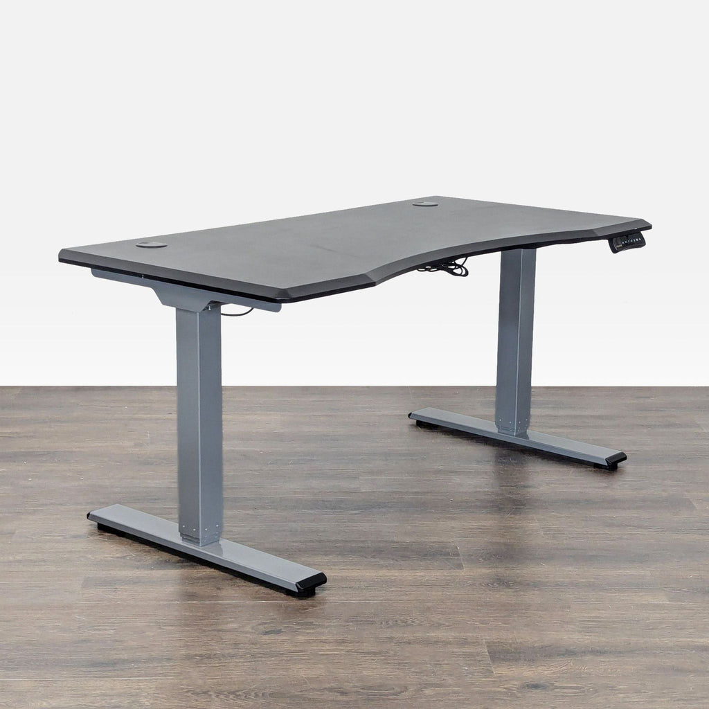 Modern black FlexiSpot desk with height-adjustable electric controls, offering ample workspace and ergonomic comfort.