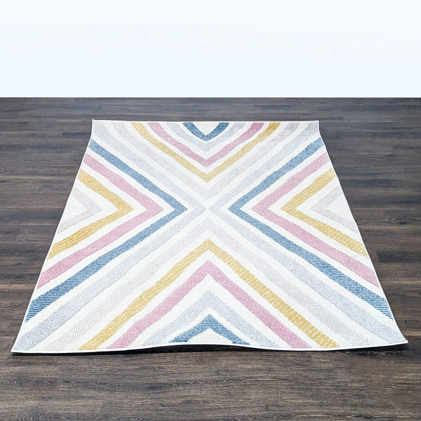 nuLOOM area rug with a bold chevron pattern in blue, pink, yellow, and white, ideal for any room.