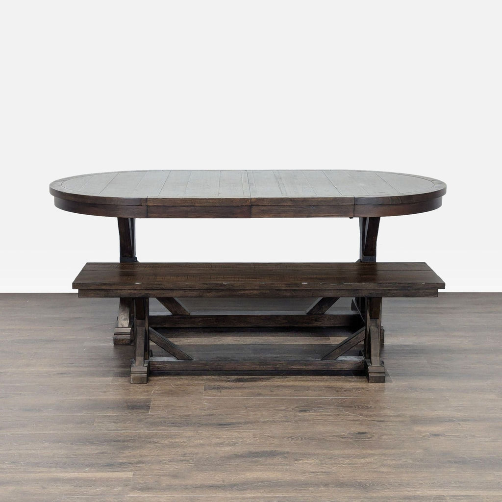 World Market dining set with large oval dark wood table and matching bench, featuring classic, sturdy design.