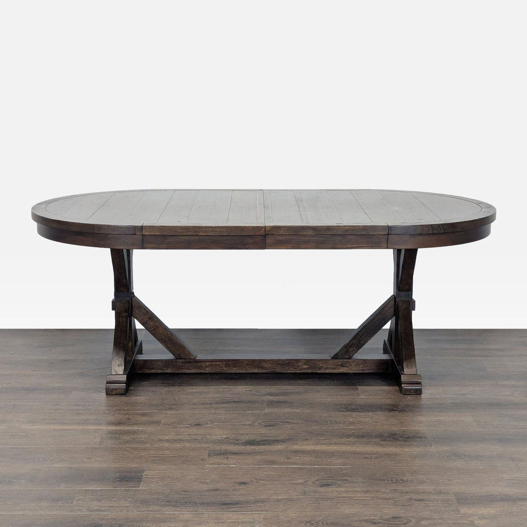 Sturdy dark wood oval dining table and bench from World Market, offering ample seating and timeless style.