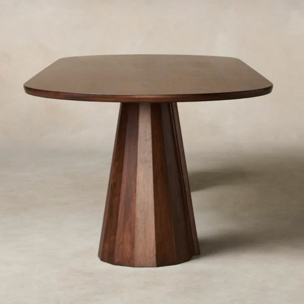 3. Handcrafted dining table with a distinctive faceted base and round beveled top by Maiden Home.