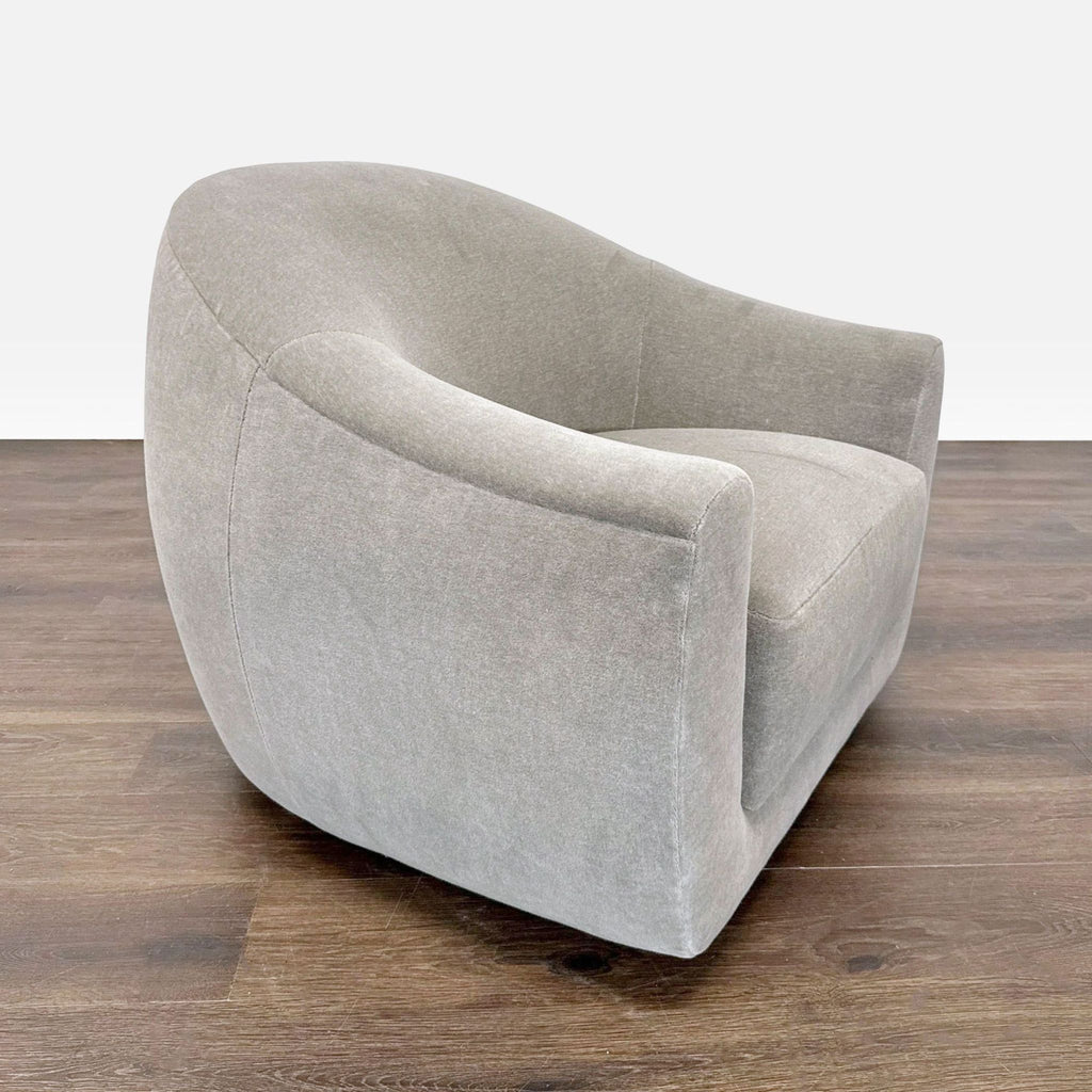 Modern swivel lounge chair by Maiden Home, featuring soft limestone fabric, rounded shape, and plush seating.