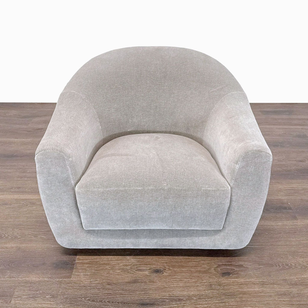 Maiden Home lounge chair with a curved silhouette, limestone upholstery, and wide cushioned seat for comfort.