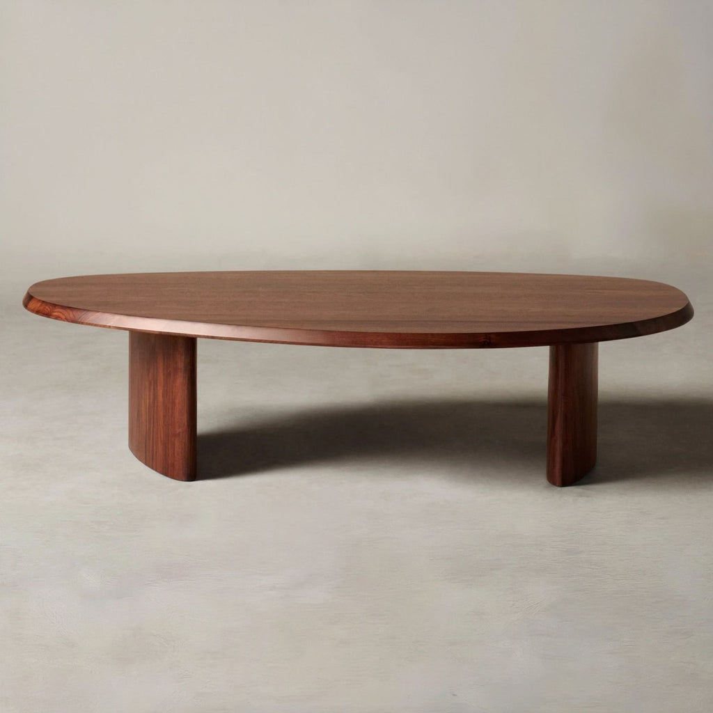 1. Oval wooden coffee table by Maiden Home with two thick legs, shown against a neutral background.