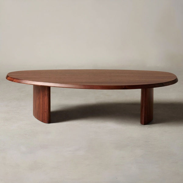 1. Oval wooden coffee table by Maiden Home with two thick legs, shown against a neutral background.