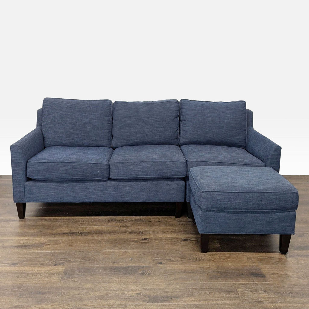 1. Pottery Barn sectional sofa in blue fabric with right-facing chaise and dark wood legs, seats three.