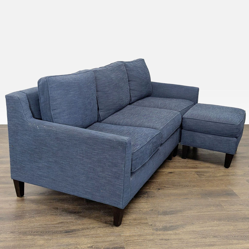 2. Modern blue Pottery Barn sectional with plush cushions and chaise, perfect for stylish living rooms.