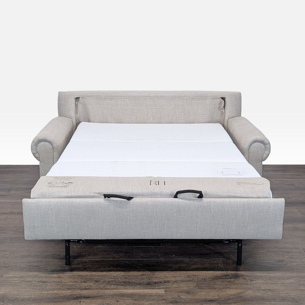 Light gray Restoration Hardware sofa features classic styling and easily converts to a Queen-size guest bed.