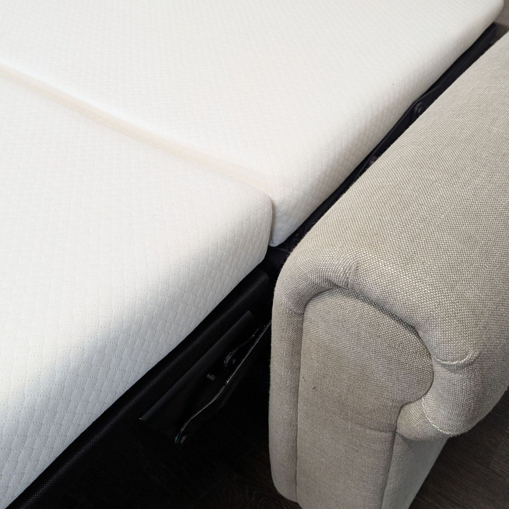 Restoration Hardware sleeper sofa with a modern design, shown in a living room setting.