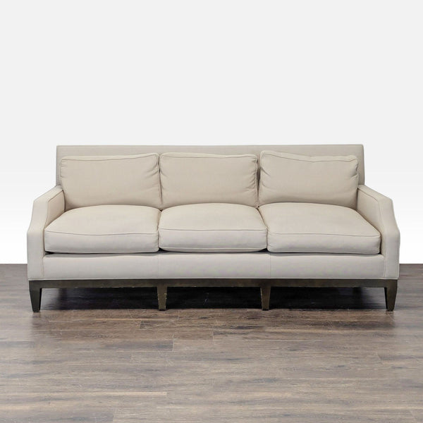 Modern beige 3-seat sofa with plush down cushions, curved arms, and wooden legs; fits any living room decor.