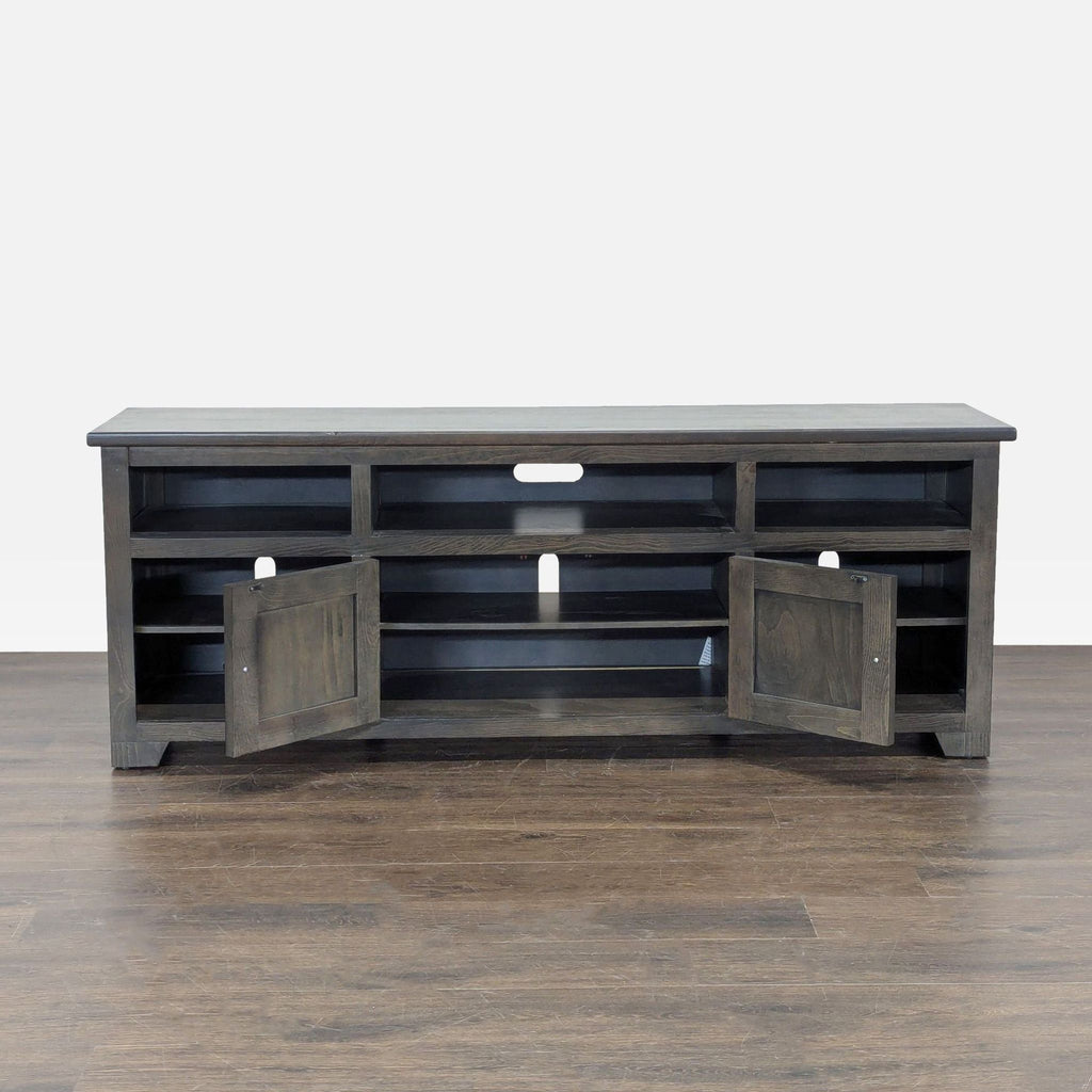 Progressive Furniture console featuring nine shelves and dual cabinets, perfect for media storage.  