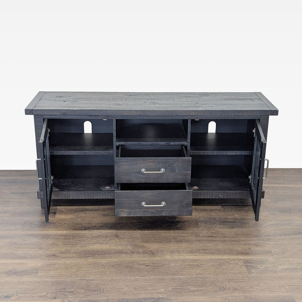 1. Black wood Living Spaces entertainment center with open doors and drawers, showing storage compartments.  