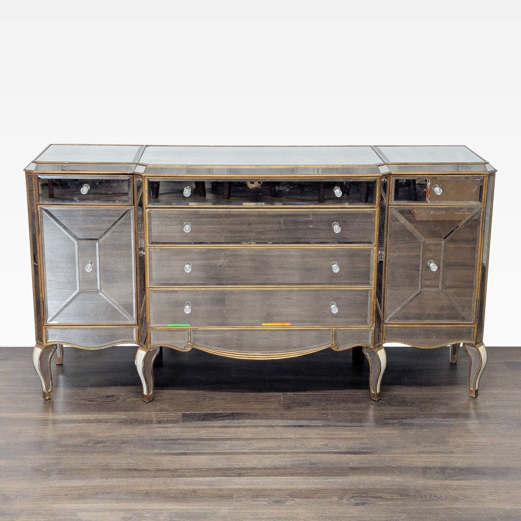 1. Mirrored sideboard by Bassett Mirror Company with elegant drawers and cabinets, shown against wood flooring.