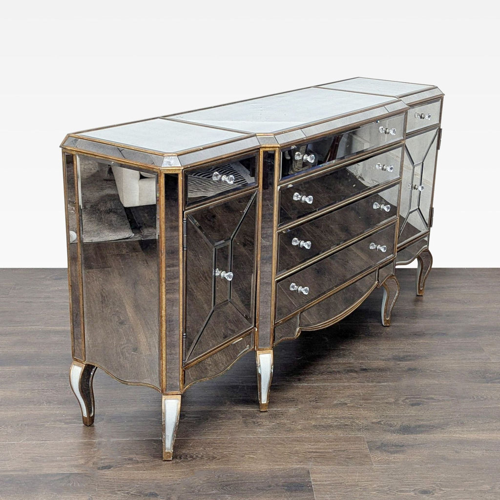 3. Angled view of a mirrored Bassett Mirror Company credenza with ornate legs and multiple storage compartments.
