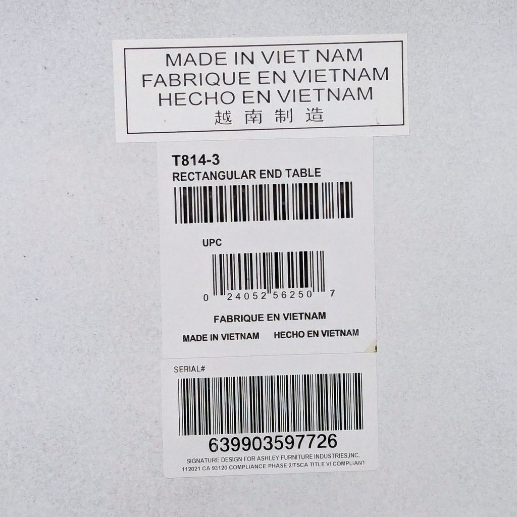 Product label for Ashley Furniture end table, includes model T814-3, UPC, serial number, and made in Vietnam.