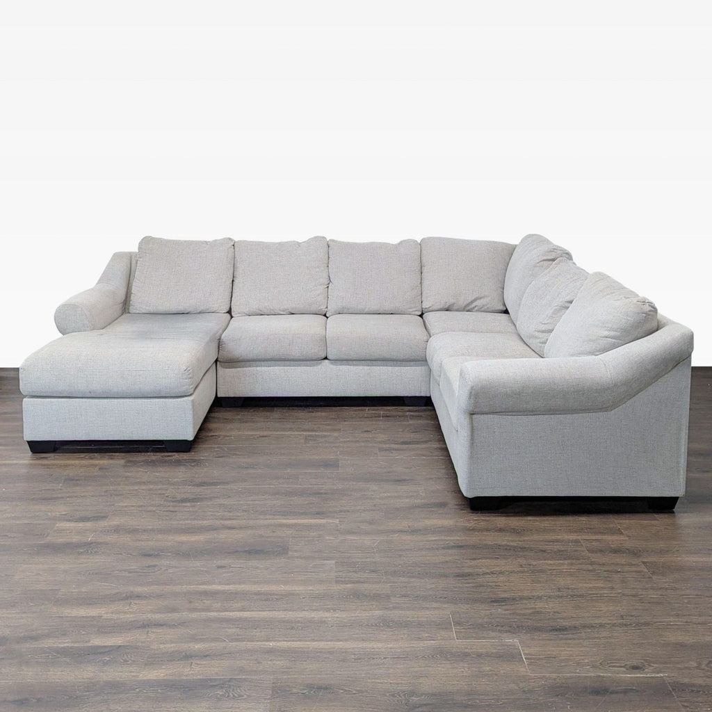 2. Ashley Furniture sectional couch in neutral tones, featuring a spacious L-shape and soft upholstery.  