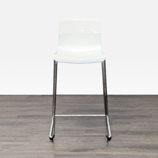 Minimalist Ikea stool with a plastic seat and metal frame, ideal for modern interiors.