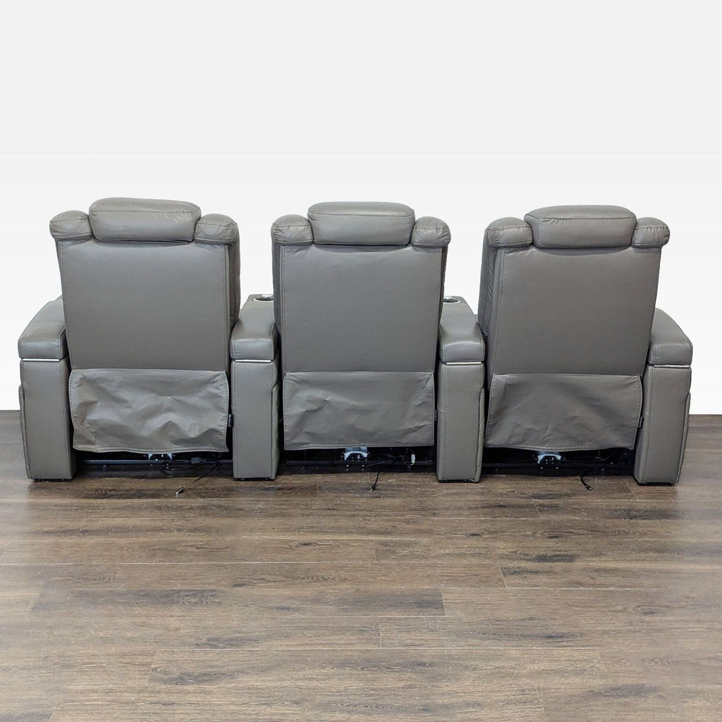 Gray leather 3-seater theater sofa by Seatcraft with power-adjustable headrest, lumbar, and reclining functions.