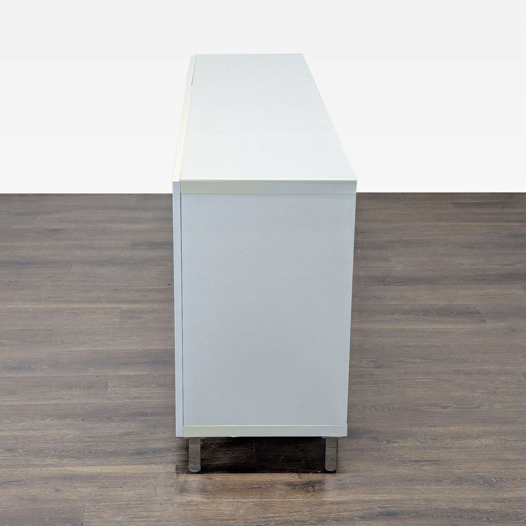 White cabinet with three doors and adjustable shelving, suited for office organization and professional environments.