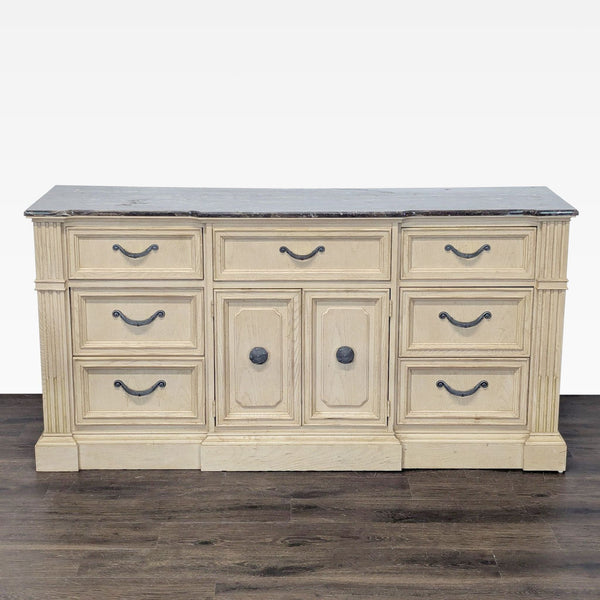 1. Stanley Furniture dresser with a marble top, light wood finish, and nine drawers for ample storage.  