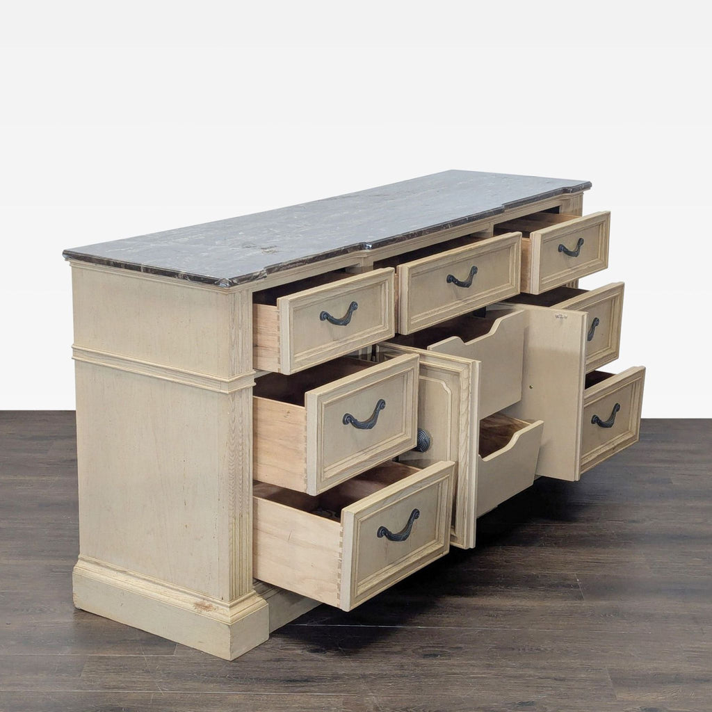 2. Light wood Stanley dresser features decorative handles, solid construction, and a stylish marble top.  