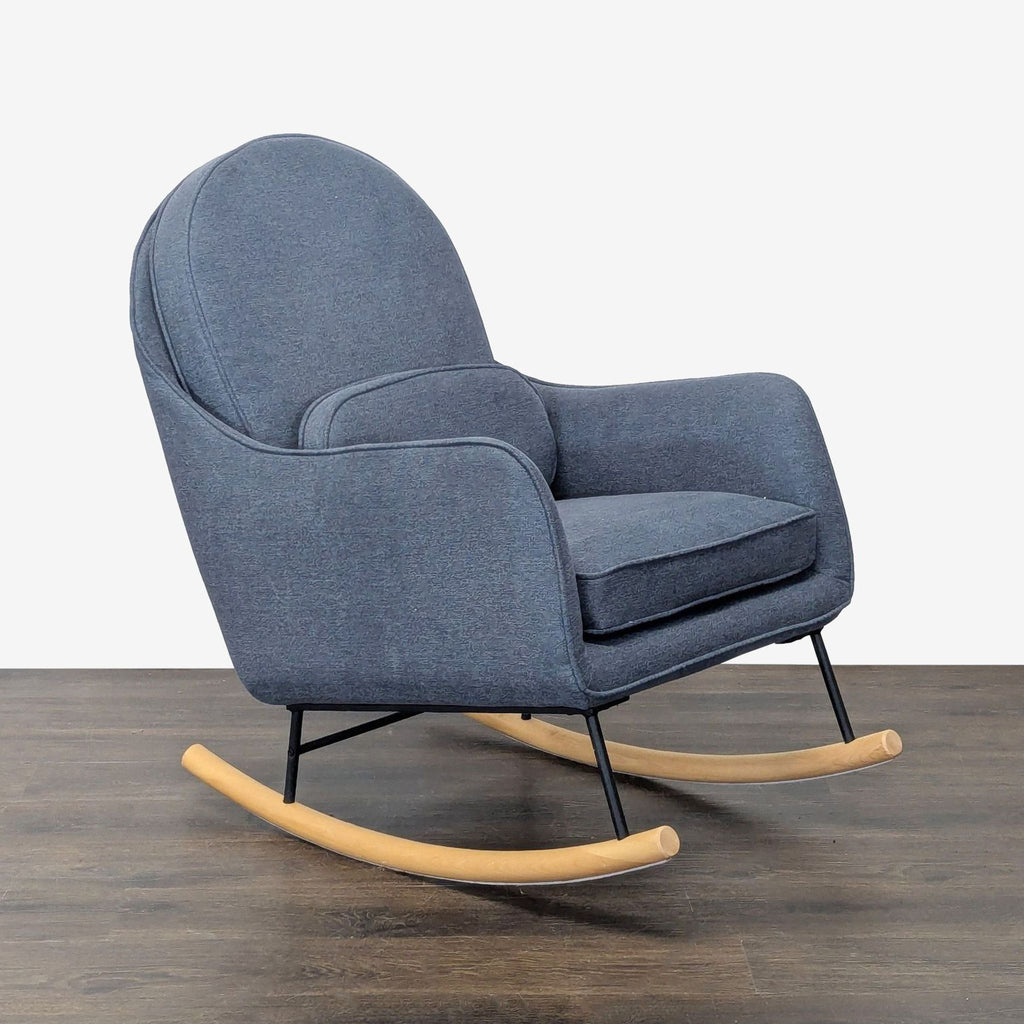 Blue fabric rocking chair by Delta Children, featuring plush cushioning and sturdy wood rockers for comfortable seating.  