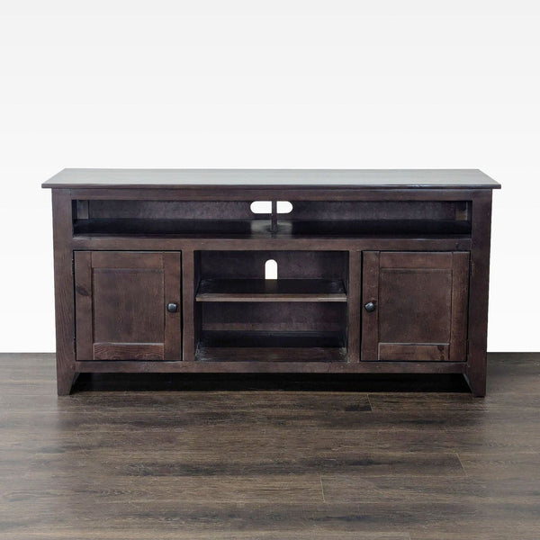 Dark pine entertainment center by Living Spaces with a modern, sleek design.  