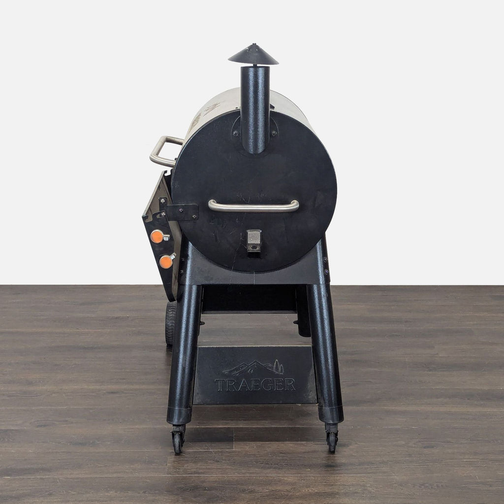 Sturdy Traeger outdoor grill with handles and wheels, perfect for barbecuing or smoking at backyard gatherings.