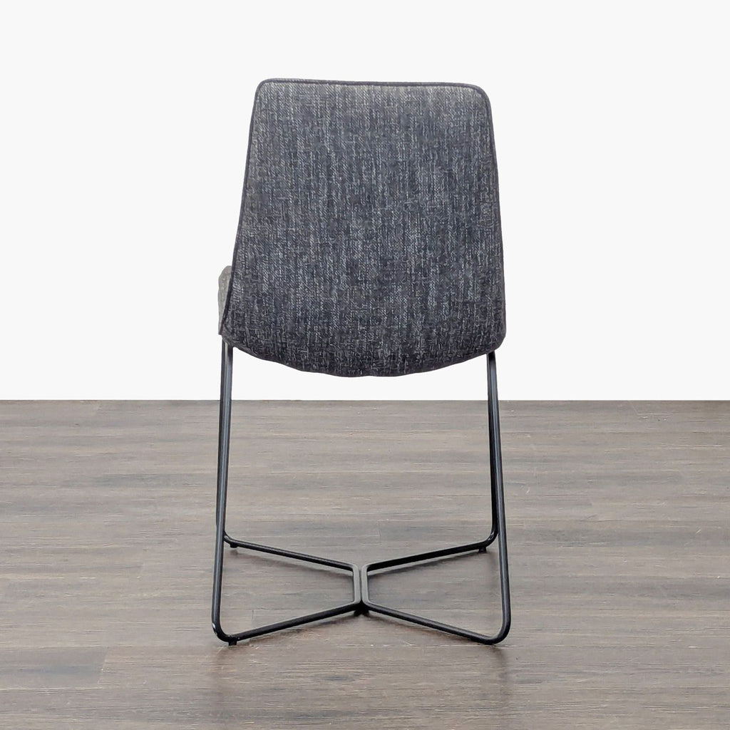 West Elm dining chair featuring an upholstered seat on a sturdy iron frame.  